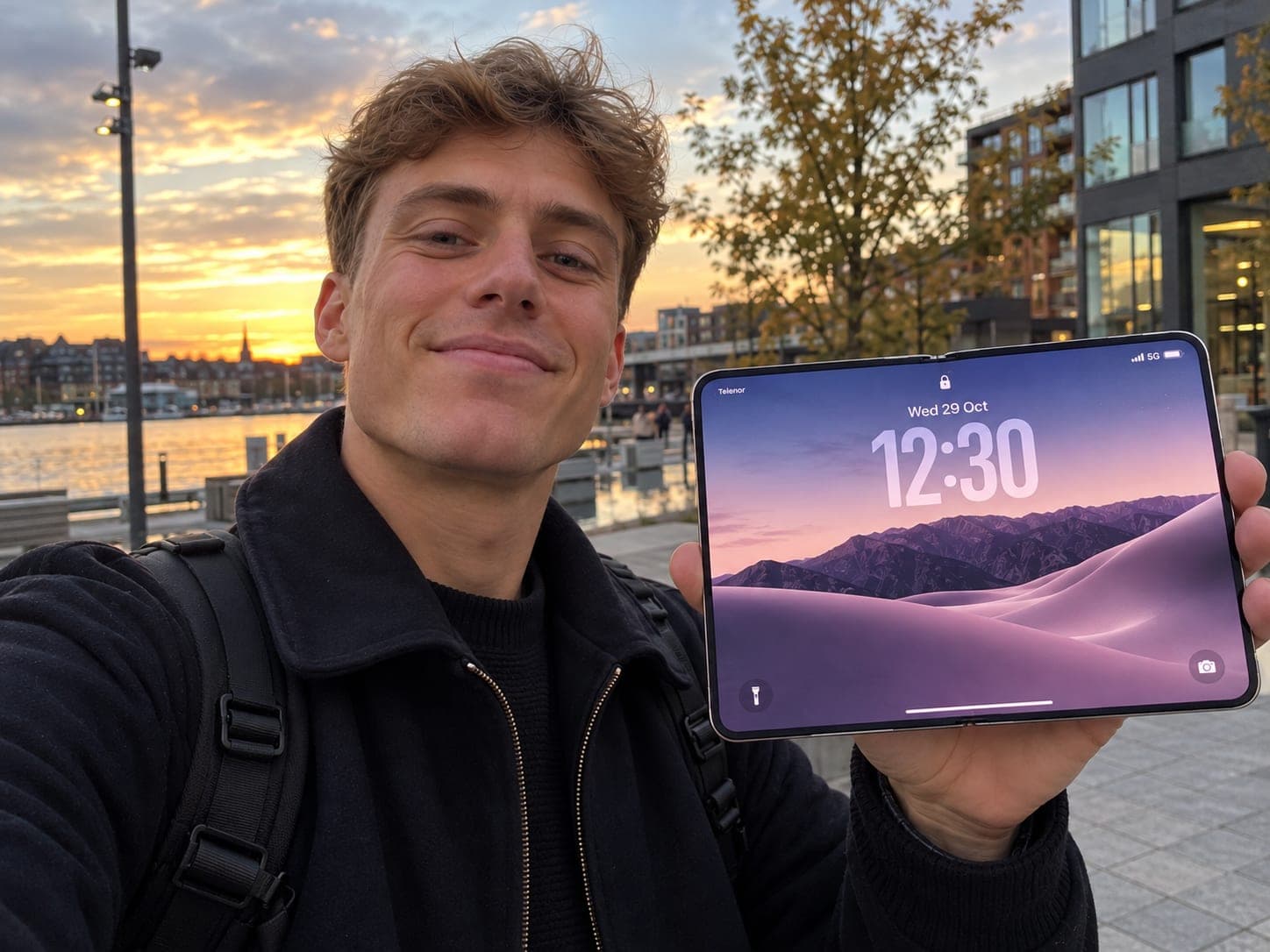 Mads, the founder of RestockRoo, holding an unfolded iPhone Duo